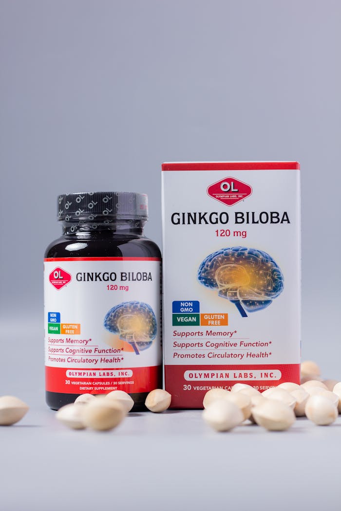 Ginkgo Biloba supplements displayed with pills on white backdrop, promoting memory and health.