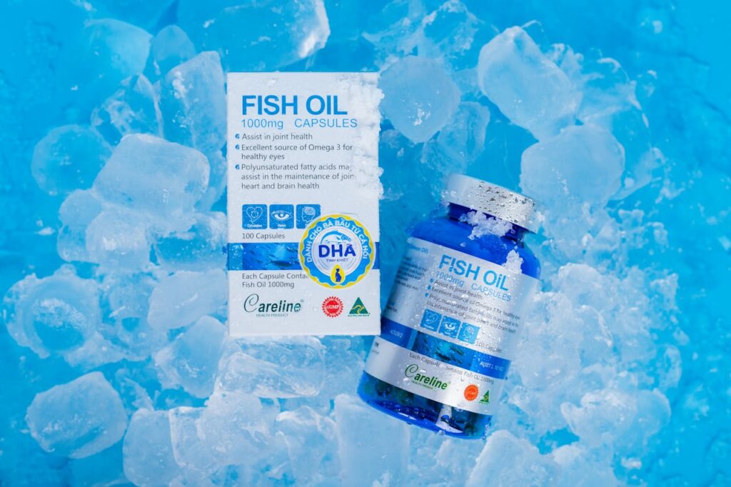 Fish oil capsules and packaging on ice, highlighting Omega 3 benefits for health.