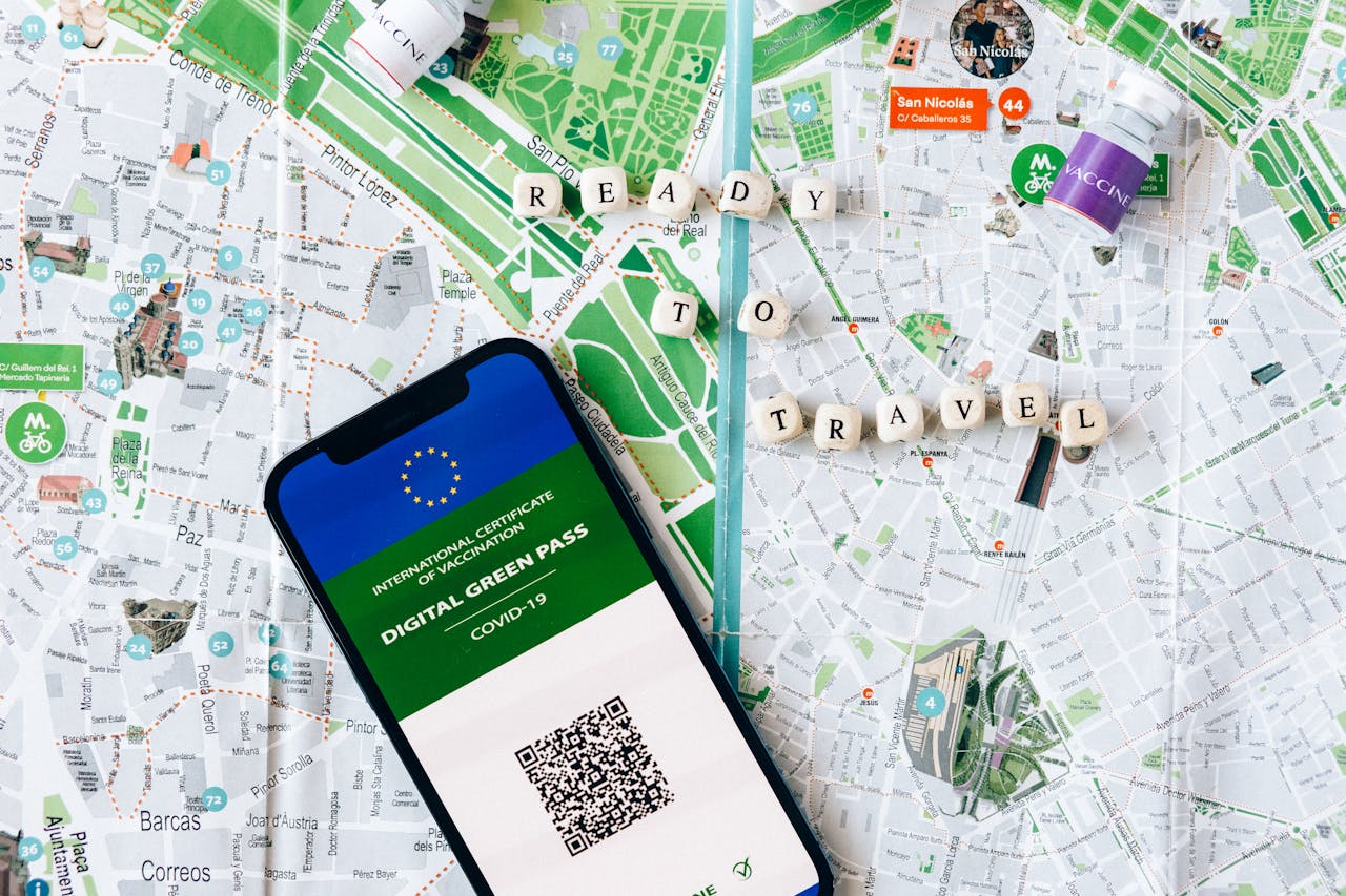 Digital Green Pass on phone with map background and travel concept.